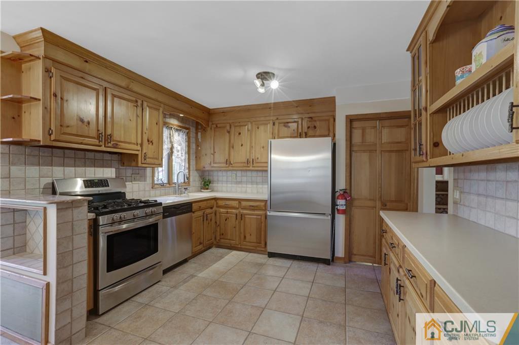 73 Ramsey Road Middlesex, NJ 08846 - Photo 14 of 25 a kitchen with stainless steel appliances granite countertop a refrigerator a stove and a sink