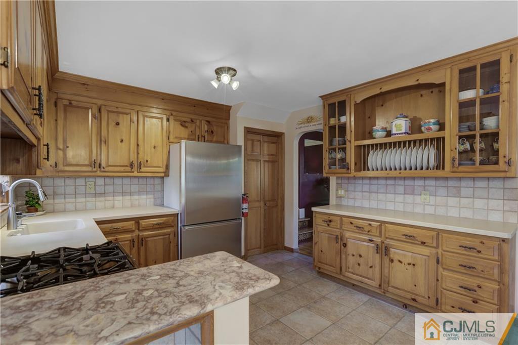 73 Ramsey Road Middlesex, NJ 08846 - Photo 15 of 25 a kitchen with stainless steel appliances granite countertop a sink stove and refrigerator