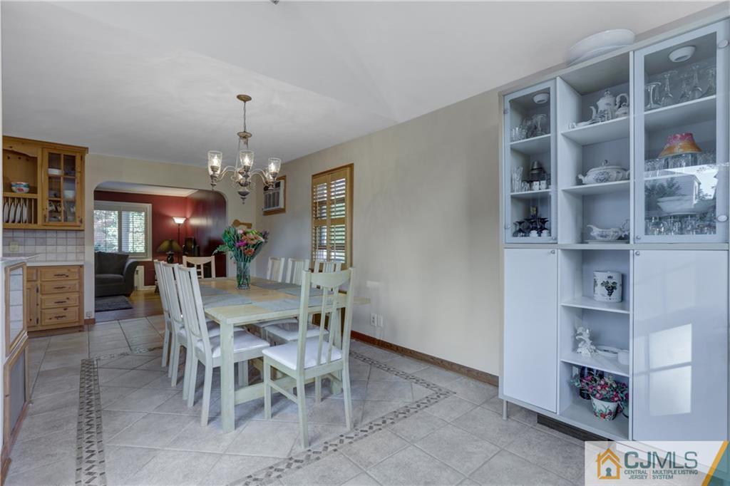 73 Ramsey Road Middlesex, NJ 08846 - Photo 16 of 25 a view of a dining room with furniture and chandelier
