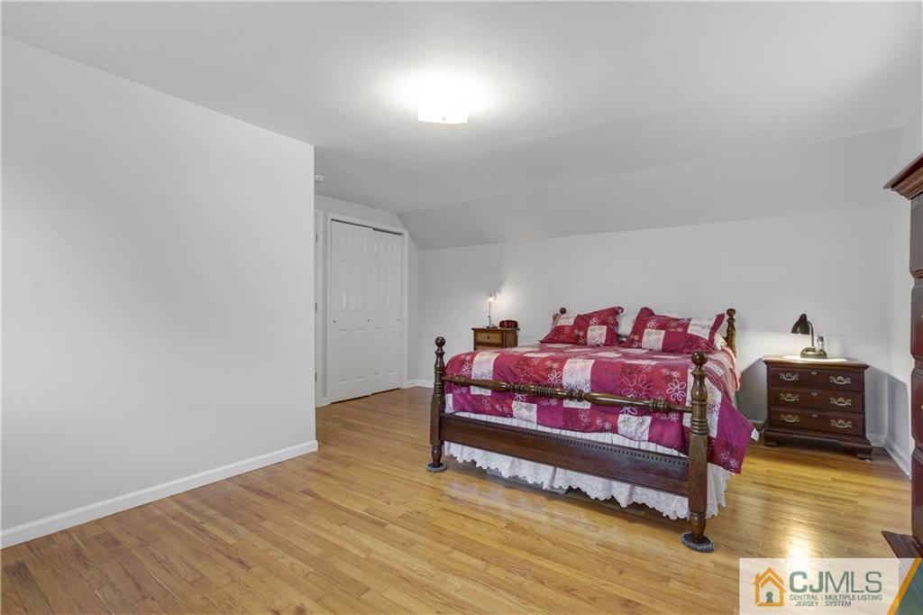 73 Ramsey Road Middlesex, NJ 08846 - Photo 18 of 25 a spacious bedroom with a bed and a wooden floor