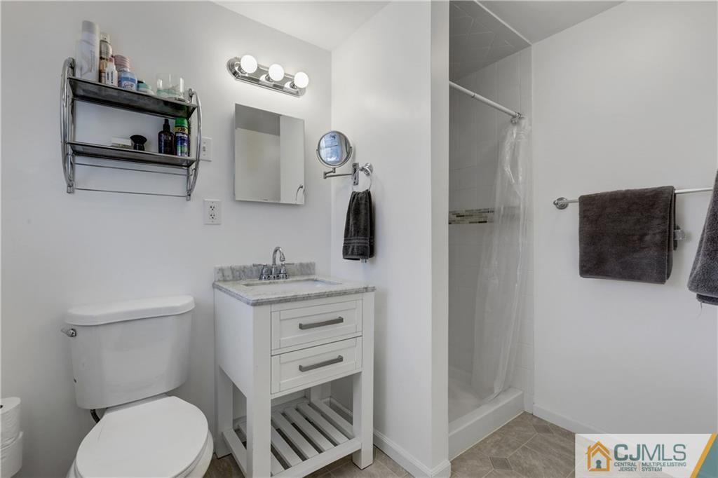 73 Ramsey Road Middlesex, NJ 08846 - Photo 21 of 25 a bathroom with a toilet a sink and mirror