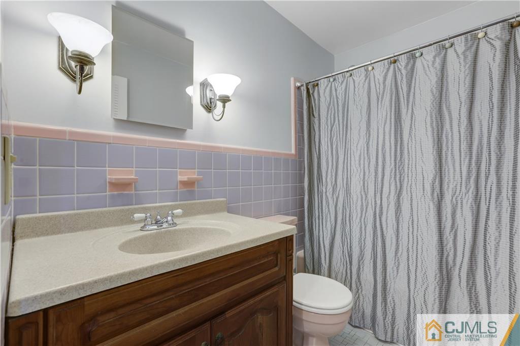 73 Ramsey Road Middlesex, NJ 08846 - Photo 24 of 25 a bathroom with a sink a toilet and a mirror