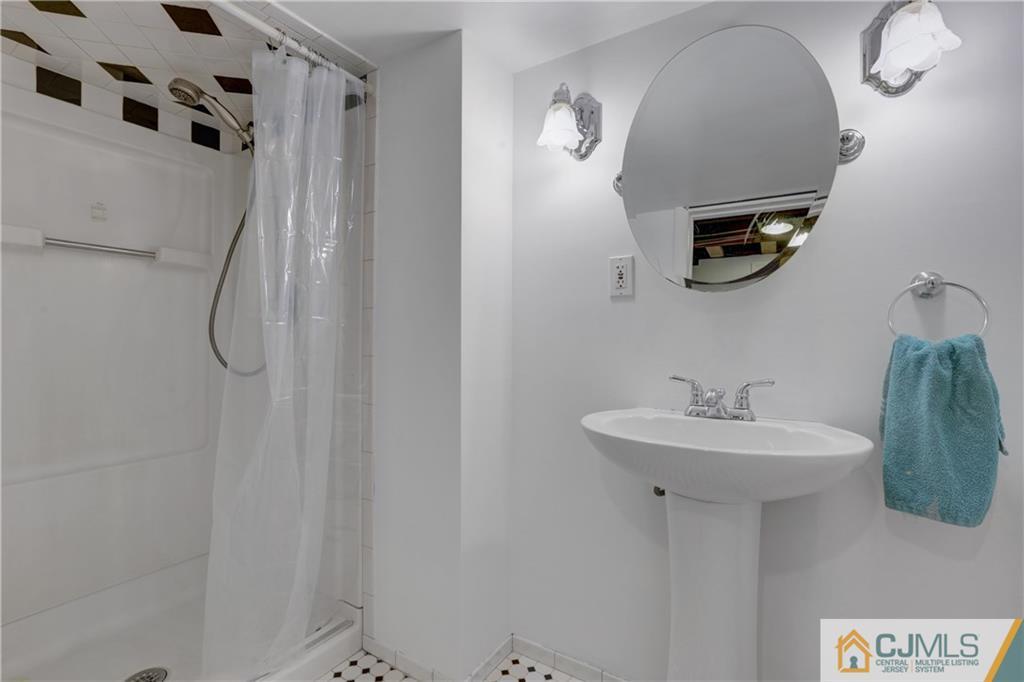 73 Ramsey Road Middlesex, NJ 08846 - Photo 25 of 25 a bathroom with a sink a mirror and shower curtain