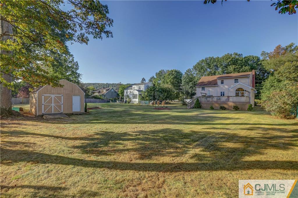 73 Ramsey Road Middlesex, NJ 08846 - Photo 5 of 25 a view of a swimming pool with a house in the background