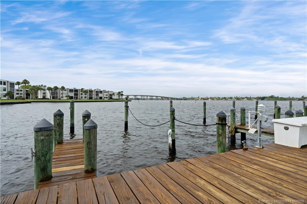 1866 Southwest Palm City Road, Unit 204 Stuart, FL 34994 - Photo 36 of 38 a view of a lake with outdoor seating