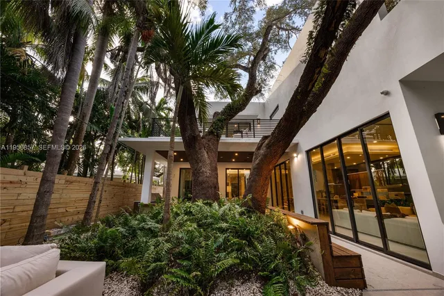 a view of an outdoor sitting area with furniture and floor to ceiling window