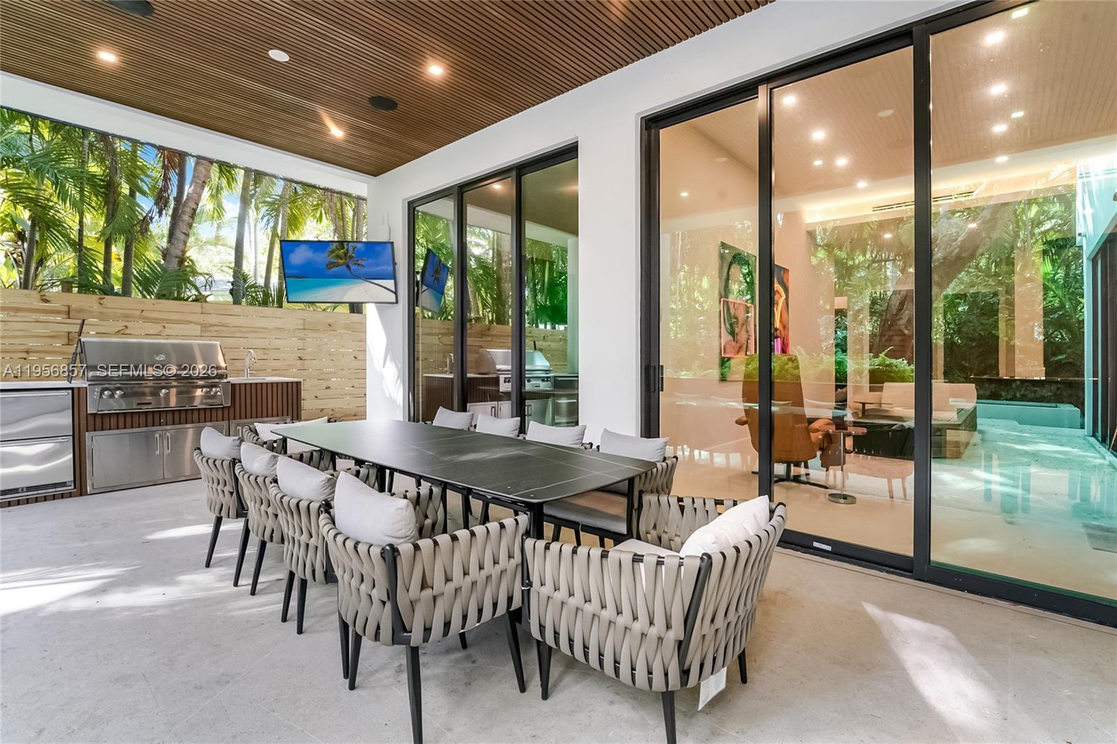 2805 Freeman Street Miami, FL 33133 - Photo 29 of 70 a dining room with furniture water view and a floor to ceiling window