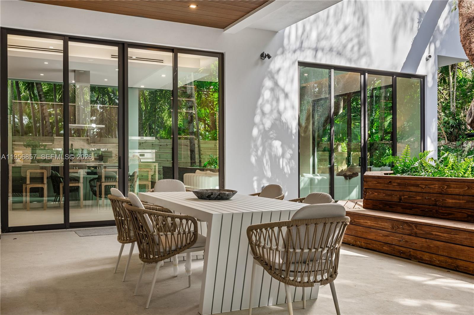2805 Freeman Street Miami, FL 33133 - Photo 29 of 92 a dining room with furniture wooden floor and a potted plant