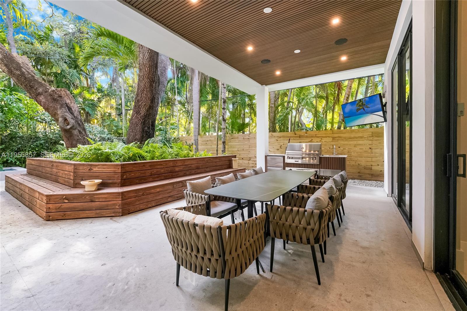 2805 Freeman Street Miami, FL 33133 - Photo 30 of 70 a outdoor dining space with furniture and garden view