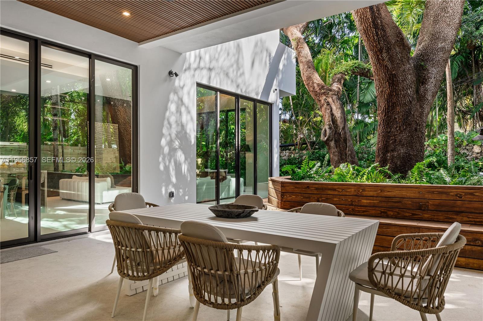2805 Freeman Street Miami, FL 33133 - Photo 30 of 92 a view of an outdoor sitting area with furniture and floor to ceiling window