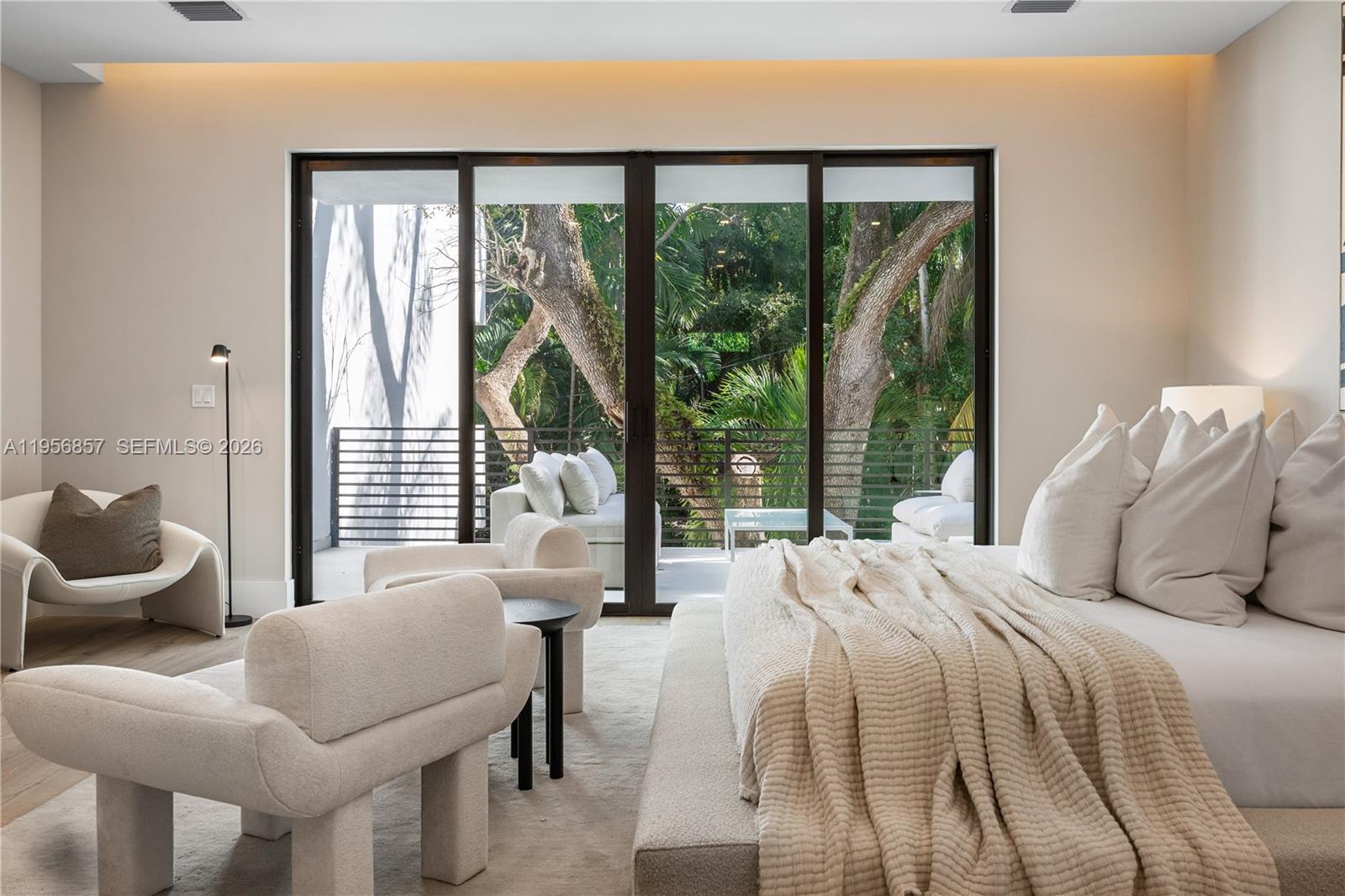 2805 Freeman Street Miami, FL 33133 - Photo 61 of 92 a bedroom with a bed and large windows