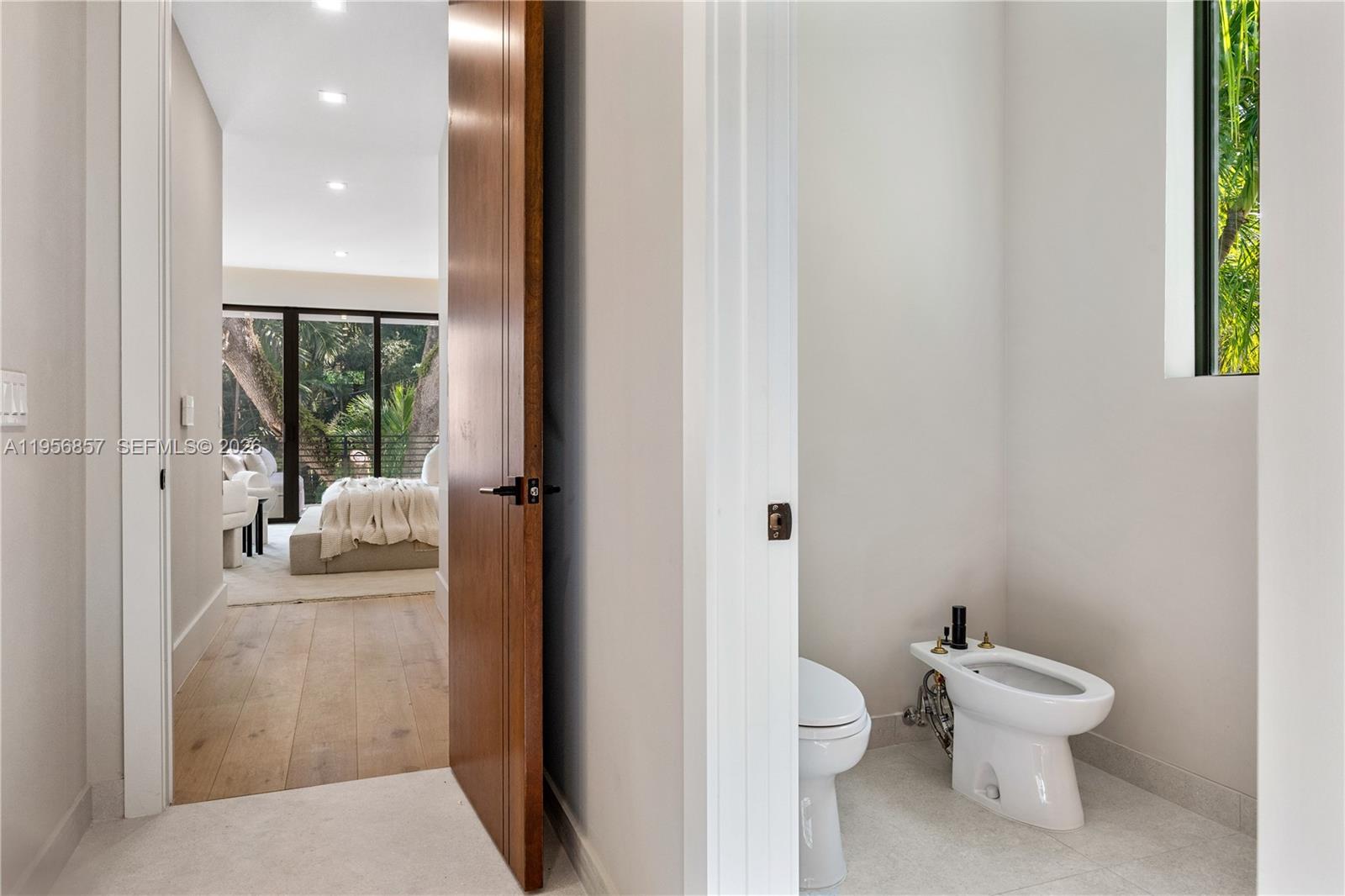 2805 Freeman Street Miami, FL 33133 - Photo 63 of 70 a bathroom with a toilet a sink and a mirror