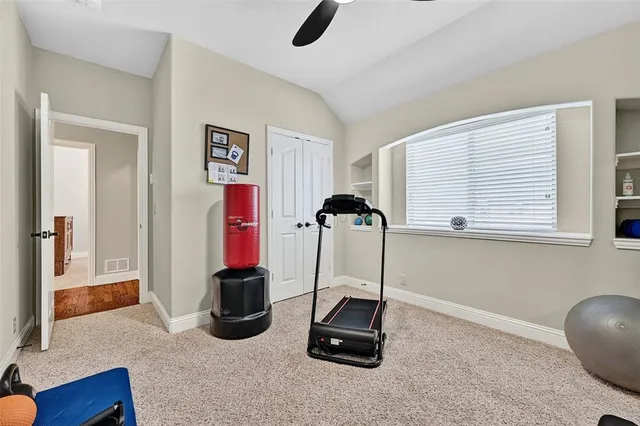 a room with gym equipment and a large window