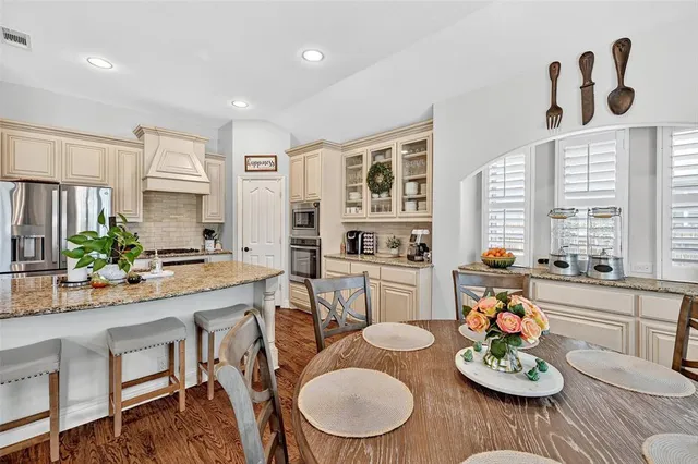 a kitchen with a table and chairs in it