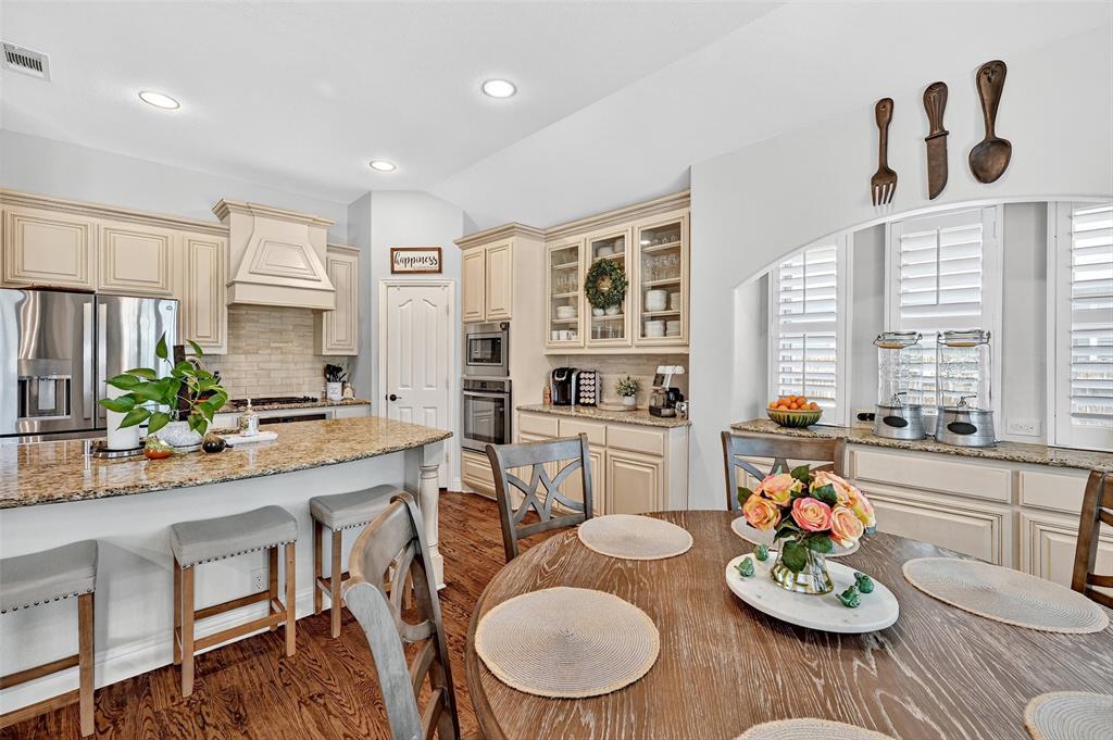 910 Calder Court Anna, TX 75409 - Photo 21 of 37 a kitchen with a table and chairs in it