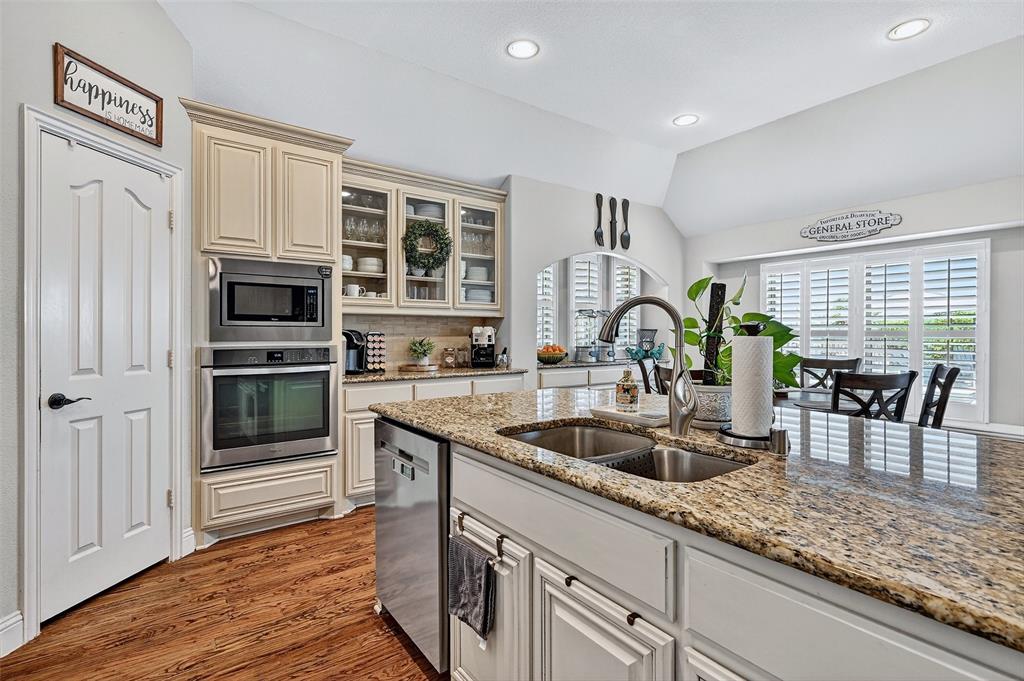 910 Calder Court Anna, TX 75409 - Photo 23 of 37 a kitchen with granite countertop a sink and a stove top oven