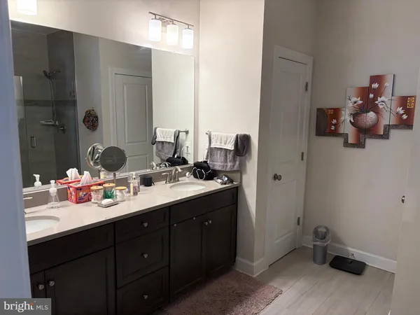 a bathroom with a sink vanity and mirror