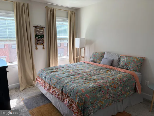 a large bed sitting in a bedroom next to a window