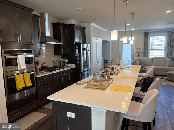 a kitchen with a dining table cabinets and appliances