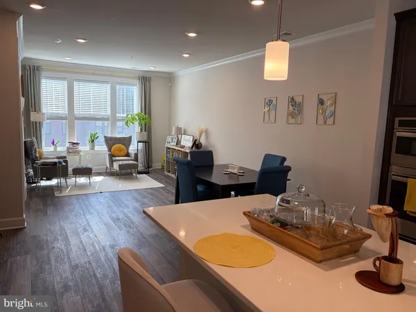 a dining room with wooden floor and glass windows