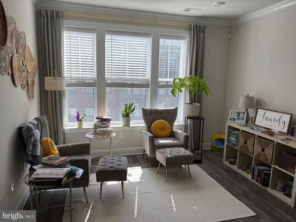 a work room with furniture and a potted plant