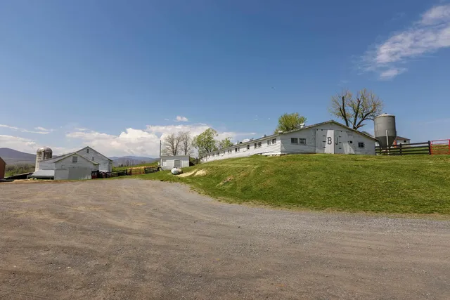a view of a house with backyard and deck