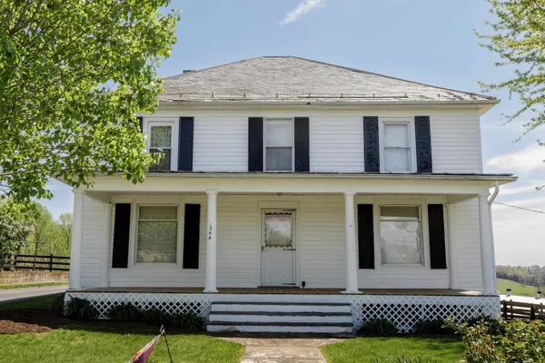 a front view of a house with a garden and yard