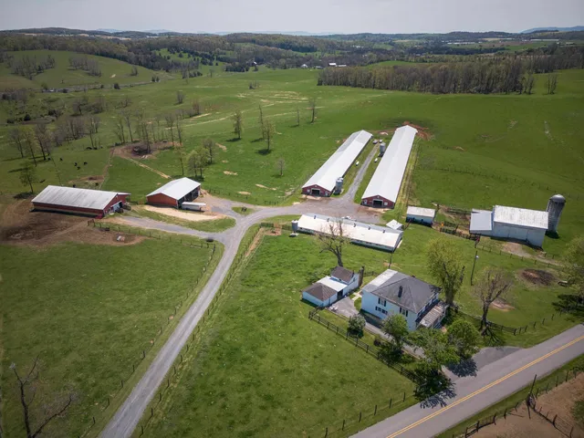 an aerial view of a house with a garden and lake view