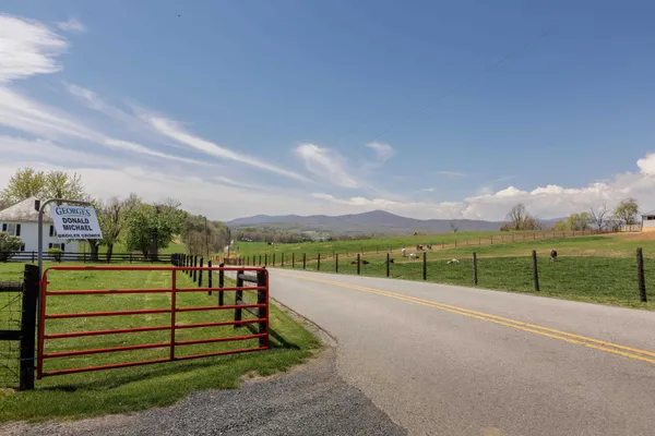 a front view of a house with yard and mountain view