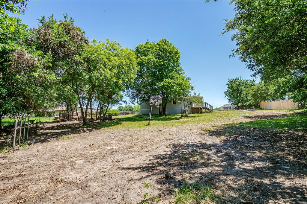 178 Valley Lake Lane Springtown, TX 76082 - Photo 29 of 33 Expansive yard space featuring mature trees providing natural shading