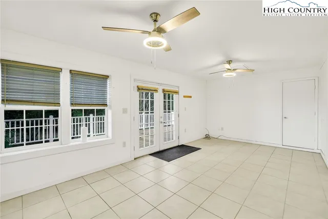 a hallway with a wooden floor and a window