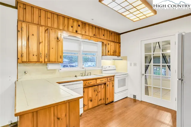a kitchen with stainless steel appliances a sink and cabinets