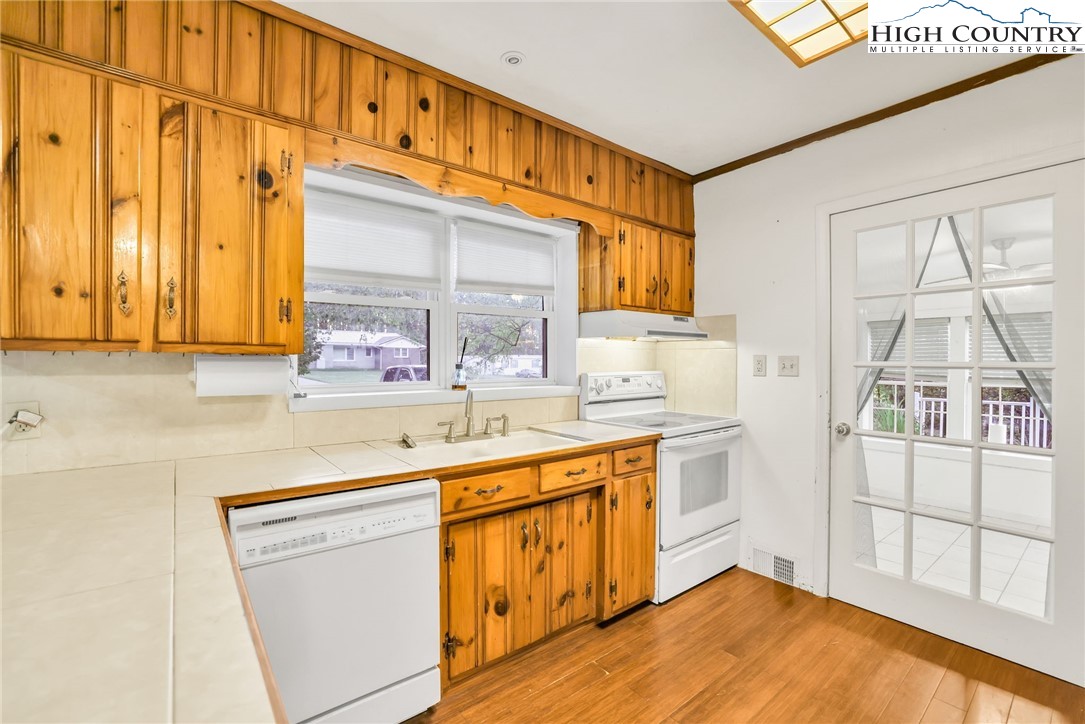 117 Andrews Ridge Road Sparta, NC 28675 - Photo 18 of 50 a kitchen with stainless steel appliances a sink and cabinets
