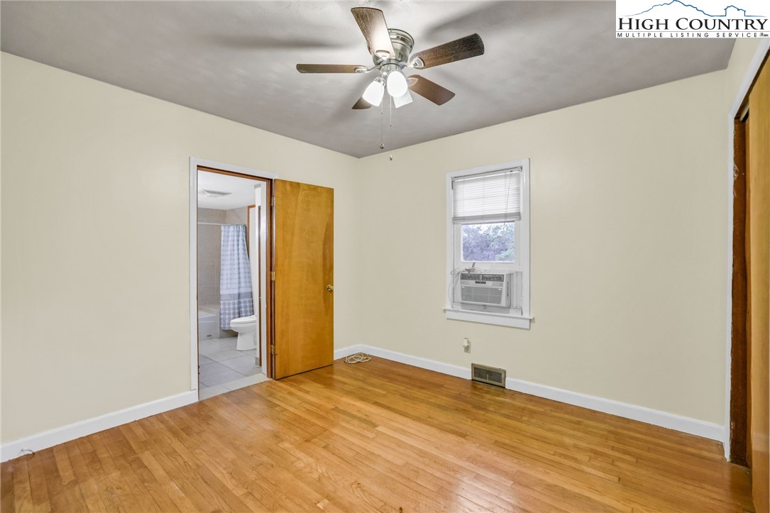 117 Andrews Ridge Road Sparta, NC 28675 - Photo 21 of 50 a view of a big room with windows and chandelier fan