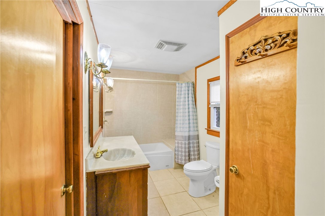 117 Andrews Ridge Road Sparta, NC 28675 - Photo 28 of 50 a bathroom with a granite countertop sink and a mirror