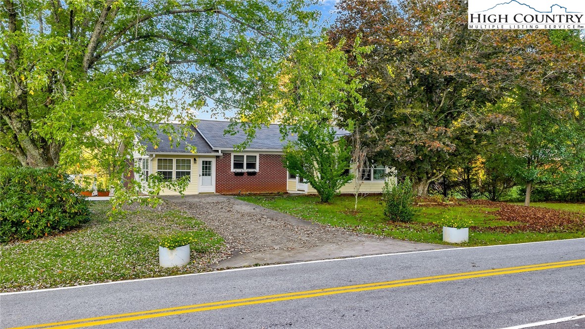 117 Andrews Ridge Road Sparta, NC 28675 - Photo 40 of 49 a front view of a house with a yard and garage