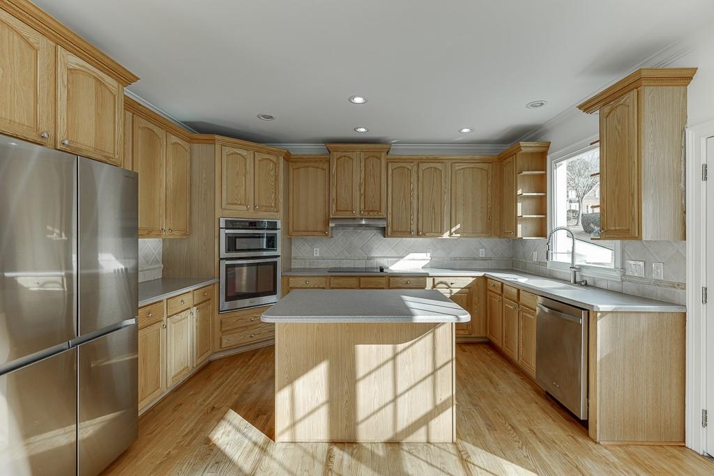 2747 Pathview Drive Dacula, GA 30019 - Photo 13 of 59 a kitchen with stainless steel appliances granite countertop a refrigerator sink and cabinets