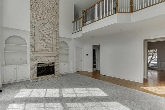 a view of an empty room with a fireplace