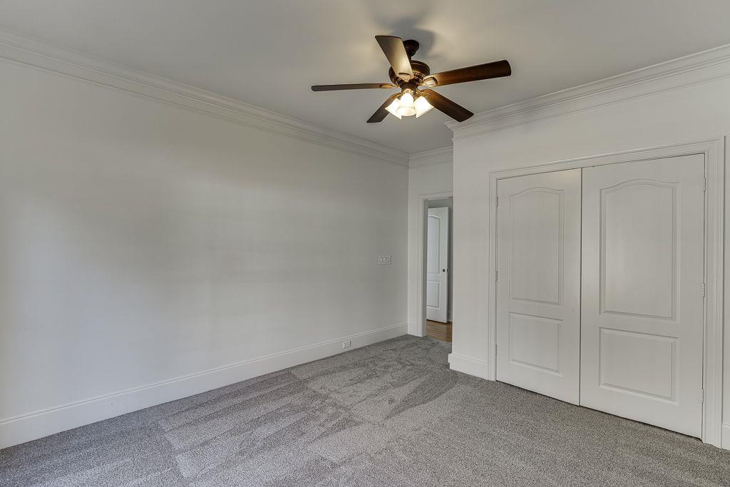 2747 Pathview Drive Dacula, GA 30019 - Photo 23 of 59 an empty room with a ceiling fan and a window