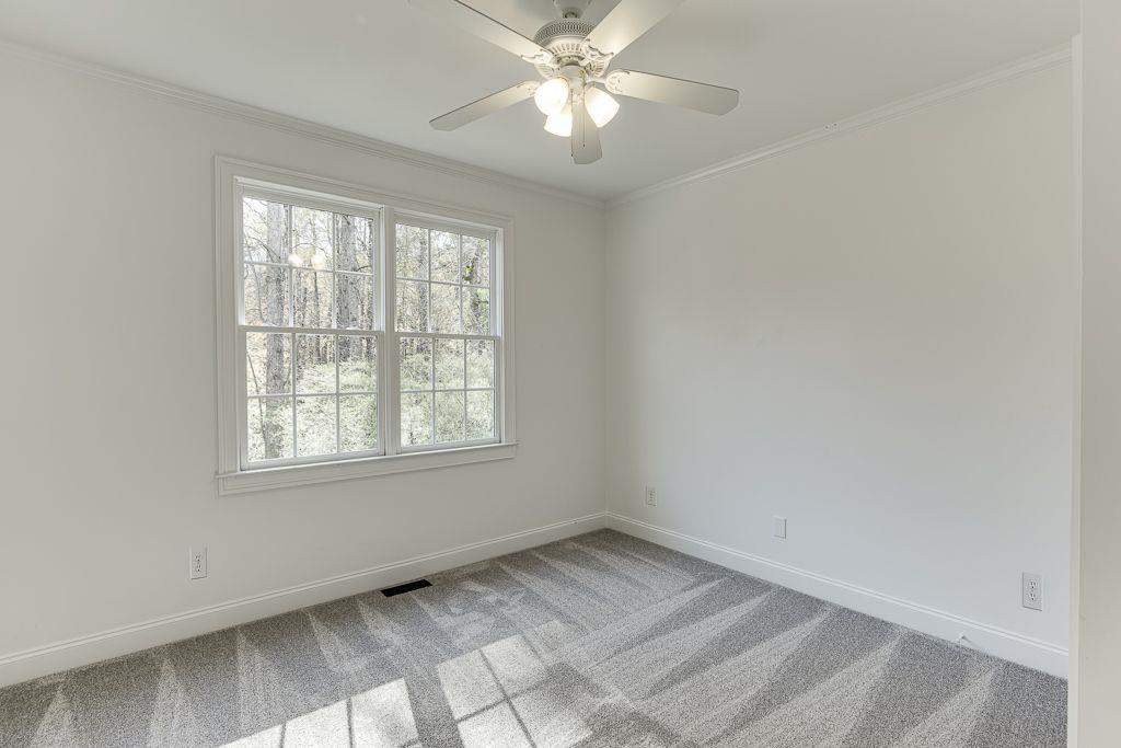 2747 Pathview Drive Dacula, GA 30019 - Photo 24 of 59 an empty room with a window and a fan