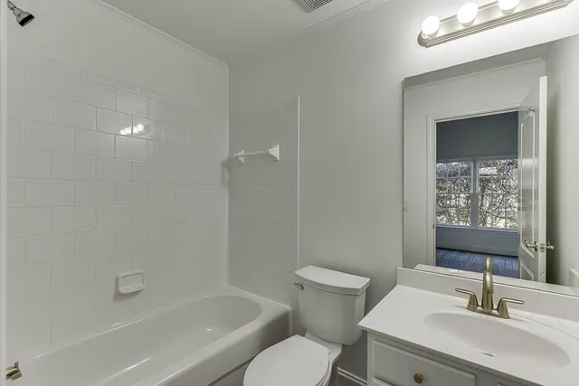 a spacious bathroom with a double vanity sink and a mirror