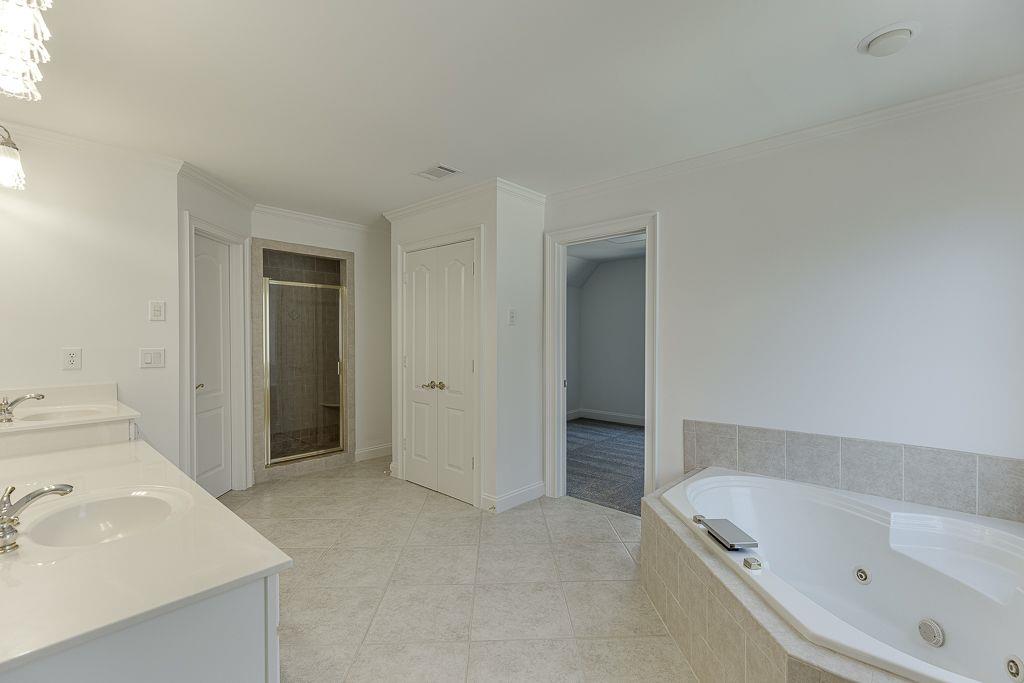 2747 Pathview Drive Dacula, GA 30019 - Photo 41 of 59 a bathroom with a tub sink and mirror