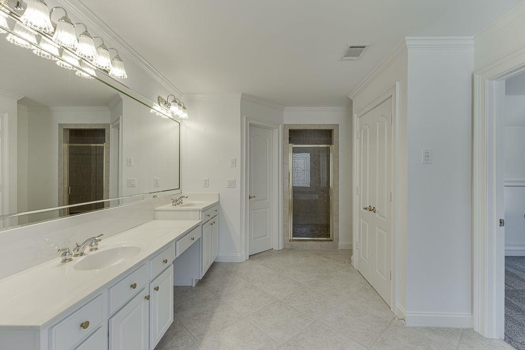 2747 Pathview Drive Dacula, GA 30019 - Photo 42 of 59 a spacious bathroom with a double vanity sink and a mirror