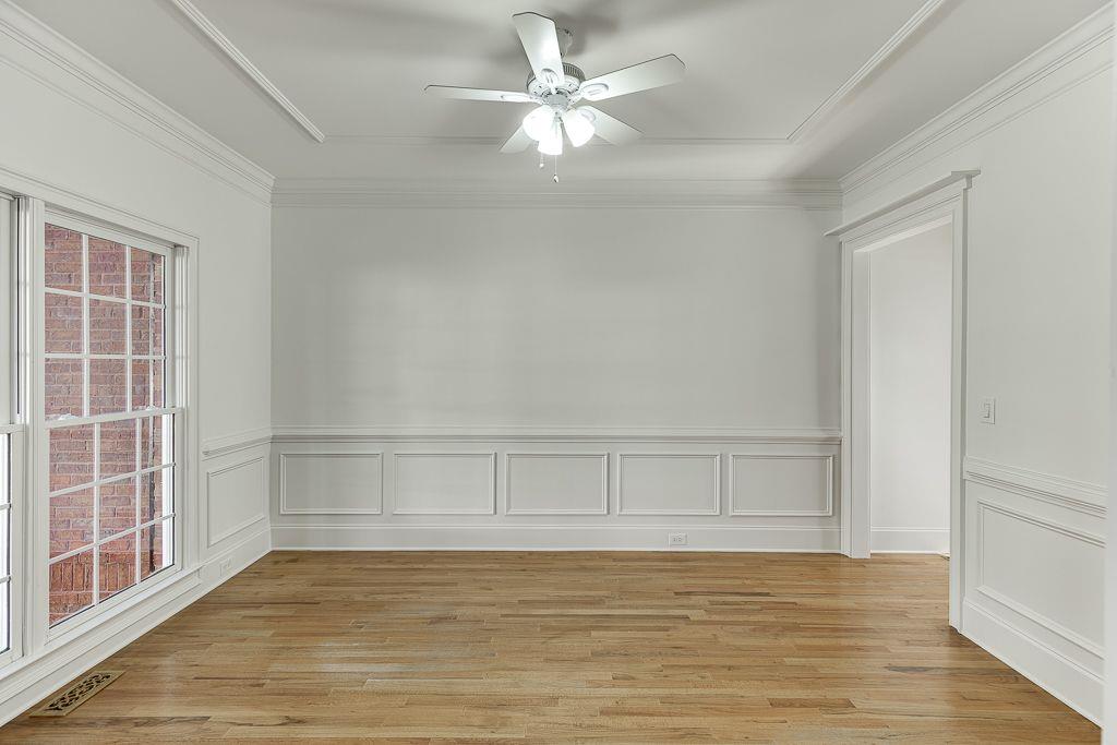 2747 Pathview Drive Dacula, GA 30019 - Photo 5 of 59 a view of an empty room with wooden floor and a window