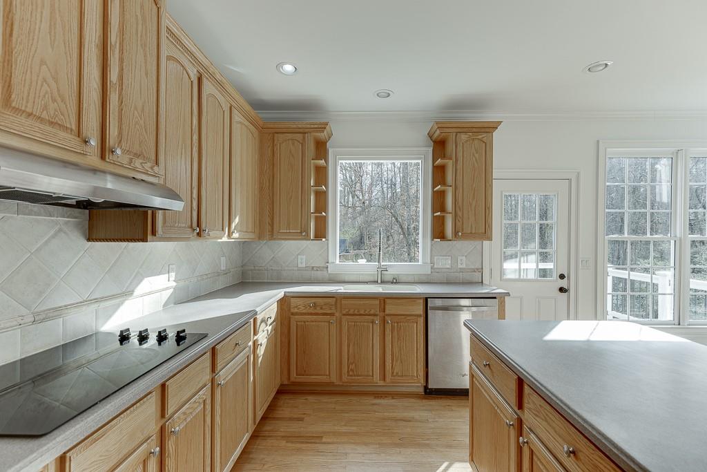 2747 Pathview Drive Dacula, GA 30019 - Photo 9 of 59 a kitchen with stainless steel appliances granite countertop a sink stove and cabinets