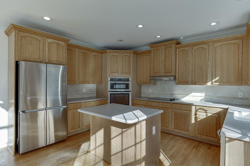 2747 Pathview Drive Dacula, GA 30019 - Photo 10 of 59 a kitchen with kitchen island a counter top space cabinets and stainless steel appliances