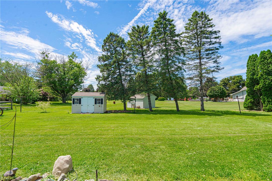579 Cherry Road Northampton, PA 18067 - Photo 48 of 57 A spacious backyard with mature trees and a functional shed offers ample outdoor living space and bonus storage.