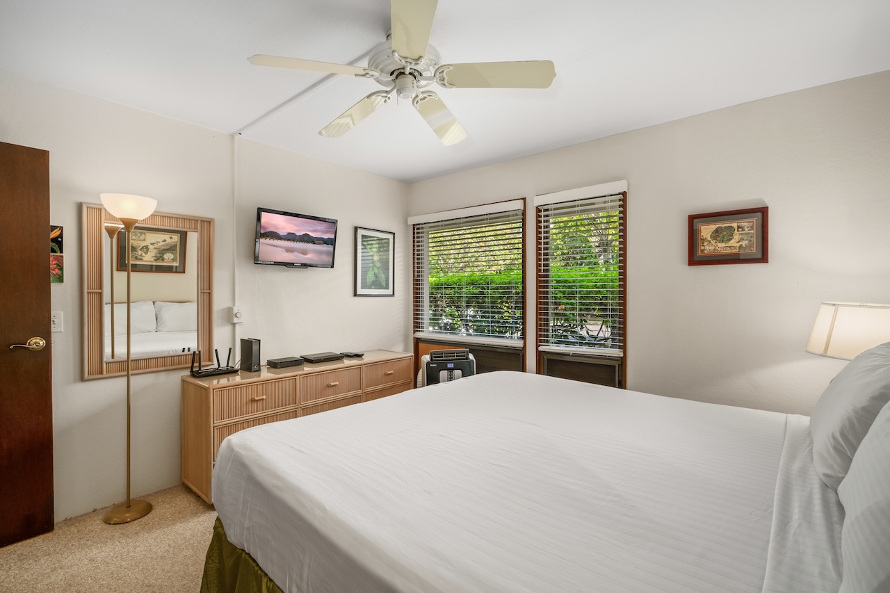 1901 Poipu Road, Unit 411 Koloa, HI 96756 - Photo 11 of 28 a large bed sitting in a bedroom next to a window