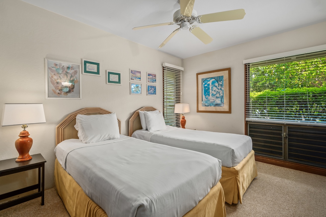 1901 Poipu Road, Unit 411 Koloa, HI 96756 - Photo 16 of 28 a bedroom with bed and a window