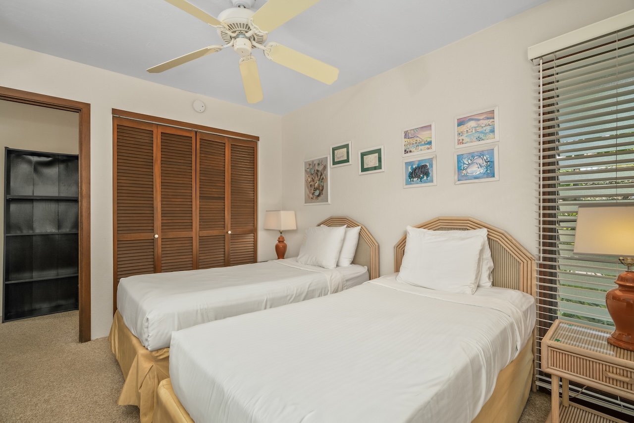 1901 Poipu Road, Unit 411 Koloa, HI 96756 - Photo 17 of 28 a bedroom with a bed and a window
